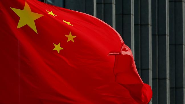 The Chinese national flag is seen on a flagpole in Beijing on August 8, 2016. Most of the five stars on the Chinese flags being used at medal ceremonies at the Rio Olympics are misaligned, officials said, prompting a diplomatic protest and online fury. / AFP PHOTO / STR