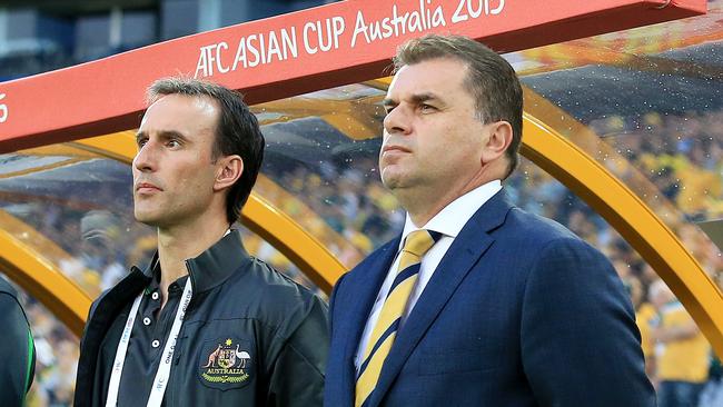 Ange Postecoglou, r, Coach of Australia, during the National Anthems at the Socceroos v Oman Asian Cup game at ANZ Stadium, Sydney Olympic Park. pic Mark Evans