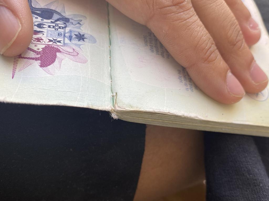 The passport appears to have a small amount of visible damage on one page.