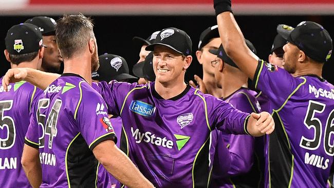 Hobart Hurricanes captain George Bailey celebrates with his teammates after they beat the Brisbane Heat on Wednesday night.