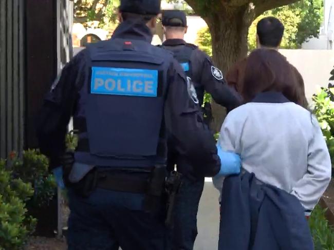 25-10-2023 - Chen Zhou, 37, and Lu Jie, 28, are led away from a property on Knutsford Street, Balwyn. The pair were arrested as part of Operation Avarus-Nightwolf, conducted by the AFP.,