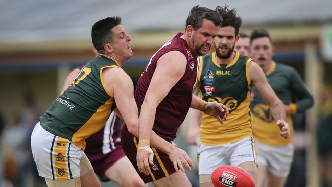 O'Sullivan Beach/Lonsdale’s Daniel Loveridge (middle), pictured against Marion last year, fought hard for the Lions against West Crodyon. Picture: AAP/Dean Martin