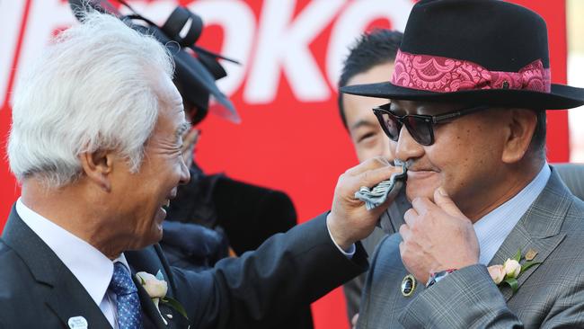 Managing owner Dr Akita cleans trainer Yoshito Yahagi's face during the Cox Plate presentation Pic: Micheal Klein