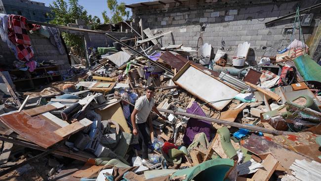 A Palestinian man searches rubble following overnight Israeli strikes in the Nuseirat refugee camp in the central Gaza Strip on June 18. Picture: AFP