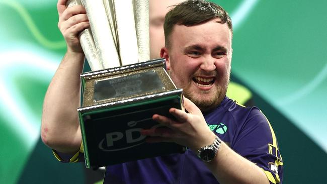 LONDON, ENGLAND - JANUARY 03: Luke Littler of England lifts the trophy as he celebrates winning the Final against Michael van Gerwen of The Netherlands during day sixteen of the 2024/25 Paddy Power World Darts Championship at Alexandra Palace on January 03, 2025 in London, England. (Photo by James Fearn/Getty Images)