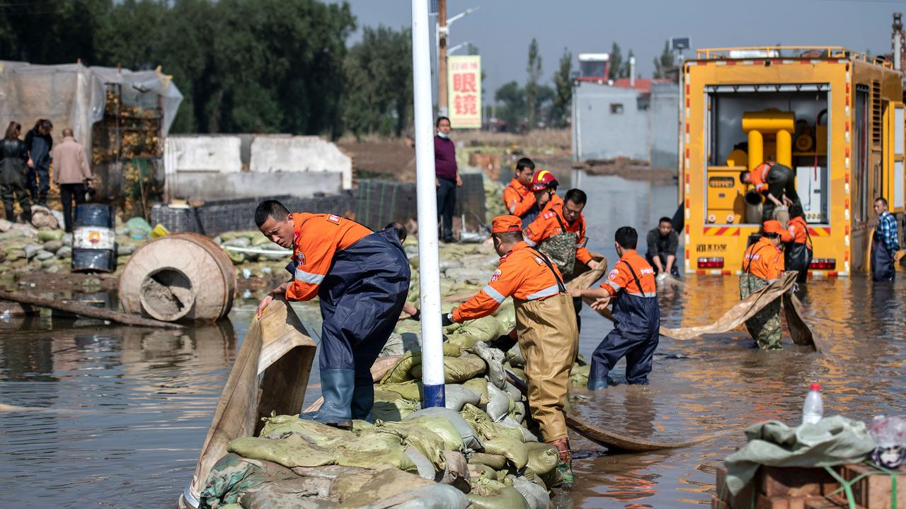 Rescue workers drain off flood waters after heavy rainfall in Jiexiu in the city of Jinzhong in China's northern Shanxi province on October 11, 2021. Picture: AFP.