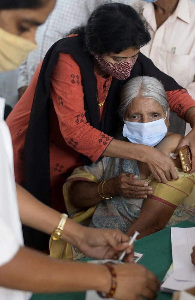 A daughter helps her mother receive a dose of vaccine in Hyderabad on Monday. Picture: Noah Seelam/AFP