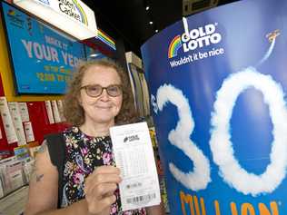 Corrie Johnston buys a ticket in the $30 million Gold Lotto from Newsextra Central City, Thursday, December 28, 2017. Picture: Kevin Farmer