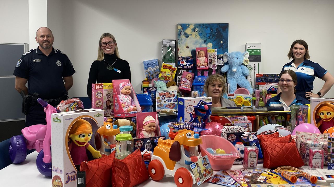 Proserpine police officer in charge Sergeant Mark Flynn presents donations to Whitsunday Counselling Service staff Tayla Pearson, Amanda Jensen, Tahlia Richardson, and Rylee Bird. Photo: Supplied.