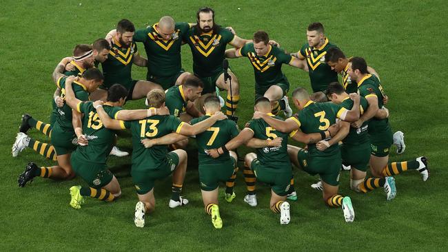 Australian players link arms during the pre-game ceremony.