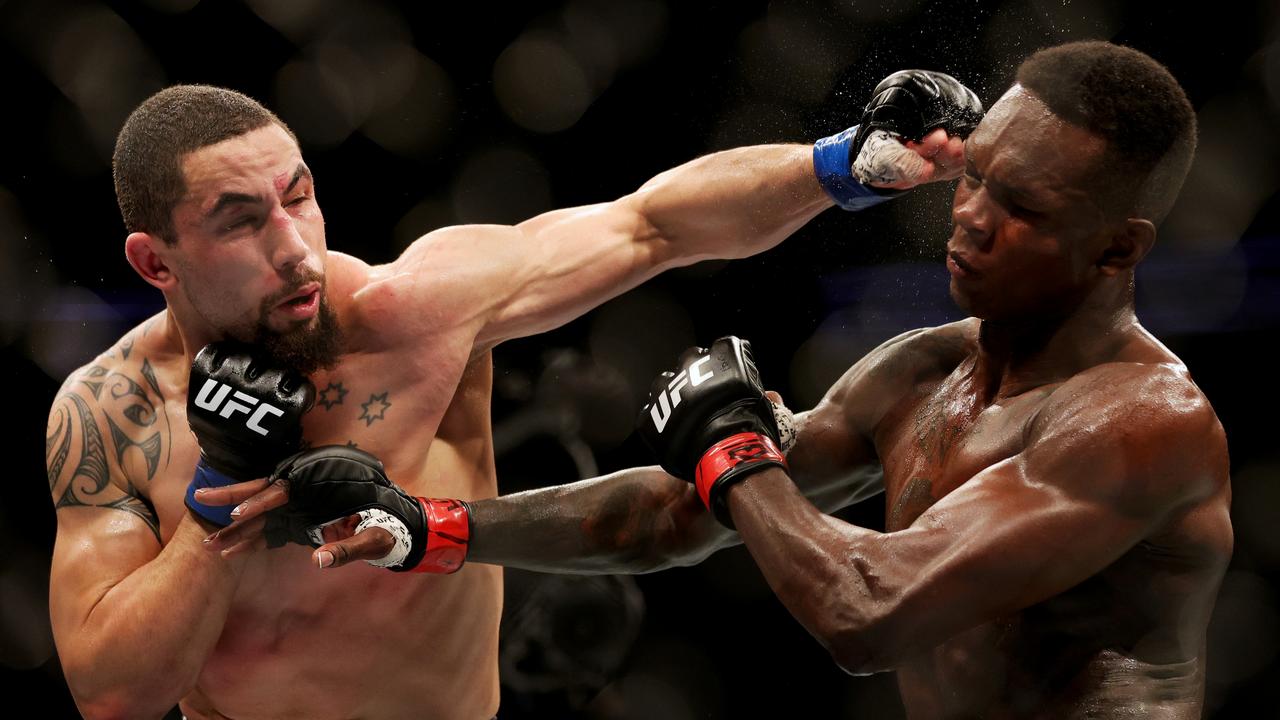 Robert Whittaker lands on Israel Adesanya at UFC 271. Picture: Carmen Mandato/Getty Images