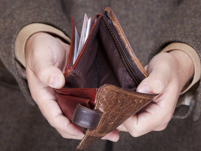 Broke businessman showing brown leather empty wallet. Business concept- finance and poor economy.