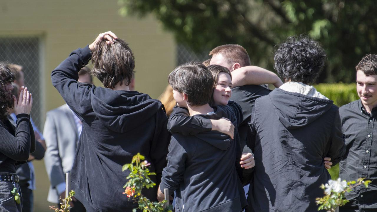 Teens offer hugs at the funeral. Picture: NCA NewsWire / Simon Bullard