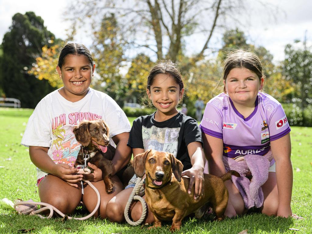 At Toowoomba's World Environment Day celebrations are (from left) Isabella Fraser, Lucia Fraser and Abby Lowe with Frankee (left) and Leo at Lake Annand Park, Sunday, June 1, 2025. Picture: Kevin Farmer