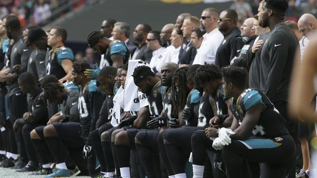 Jaguars players kneel down during the playing of the U.S. national anthem at Wembley.