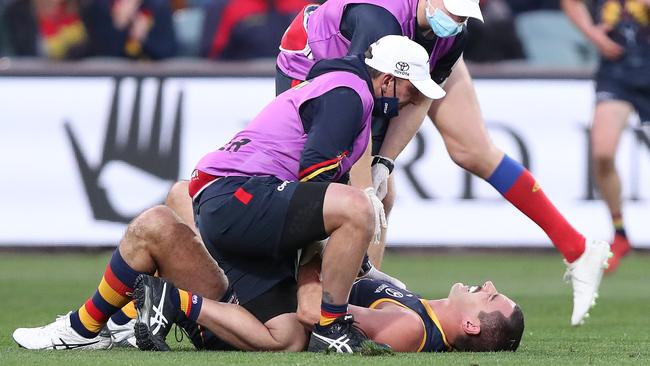 Taylor Walker lies on the turf after copping a neck injury. Picture: Sarah Reed/AFL Photos