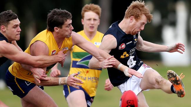 09/08/14 Nicholas Liddle attempts to kick the ball away from Luke Powell. Woodville West Torrens v South Adelaide at Woodville Oval. photo Calum Robertson