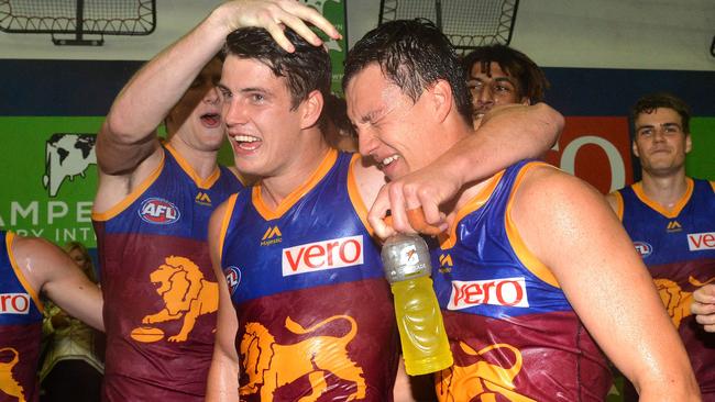 Lions players celebrate victory after beating the Fremantle Dockers.