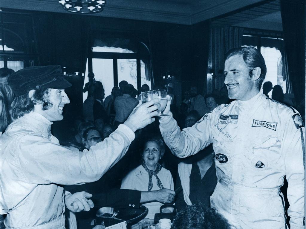 Formula One driver Jackie Stewart (left), shakes hands with the late Graham Hill.