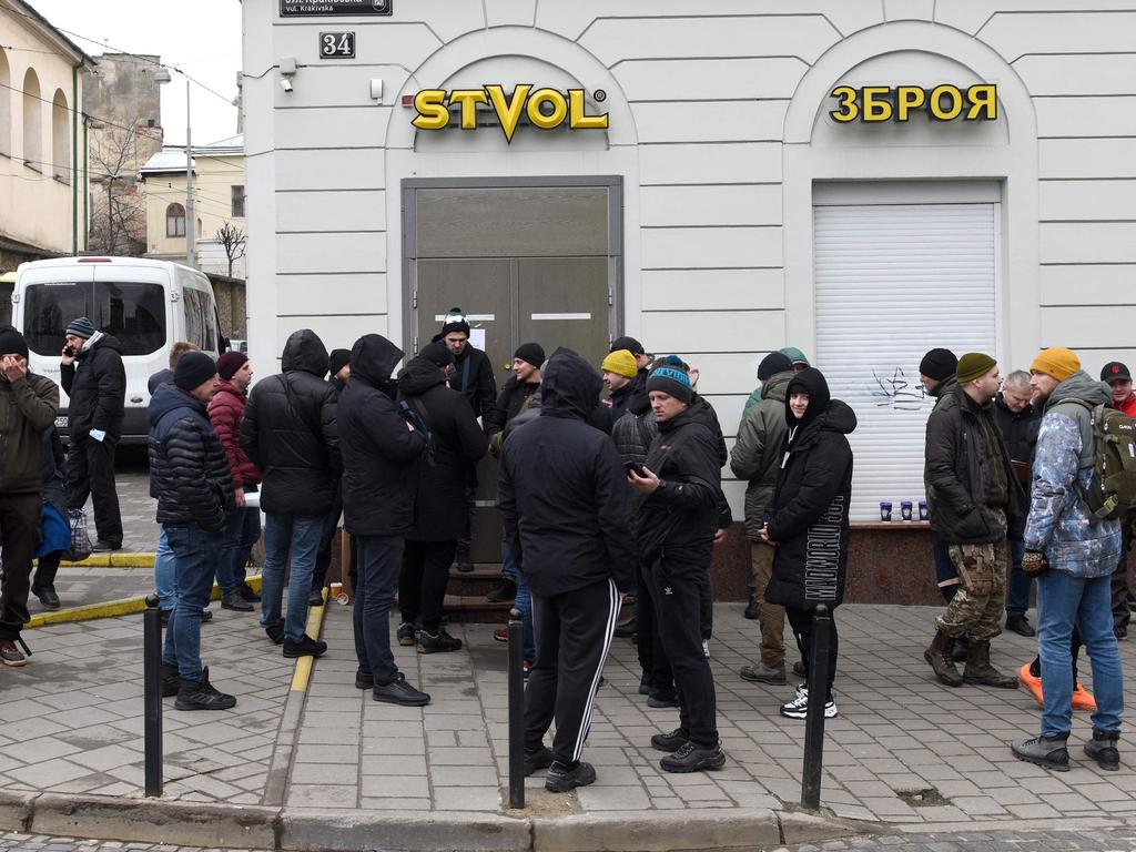 Men wait in line outside a gun shop in the western Ukrainian city of Lviv2, following Russia's invasion of Ukraine. Picture: Yuriy Dyachyshyn