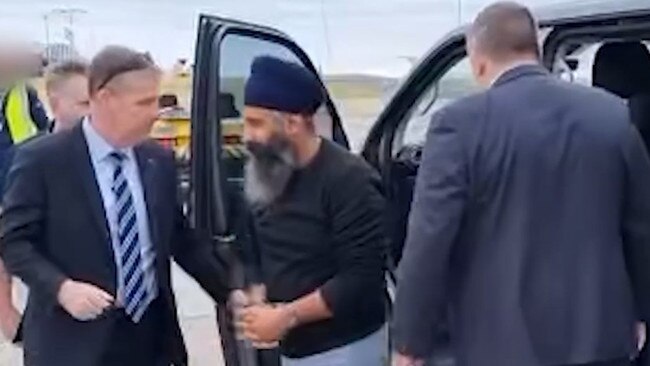 A handcuffed Rajwinder Singh is led to a private jet in Melbourne before touching down in Cairns on Thursday, March 2. Picture: Queensland Police