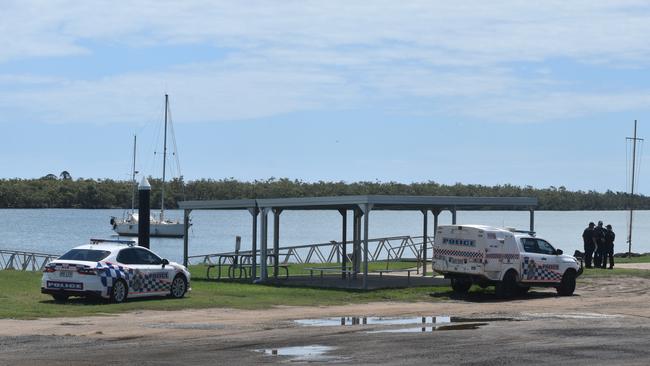 Police investigate the scene on the banks of the Burnett River and interview boaties following a serious boat crash.