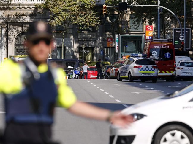 A policemen stand as he blocks the street to a cordoned off area after a van ploughed into the crowd. Picture: AFP