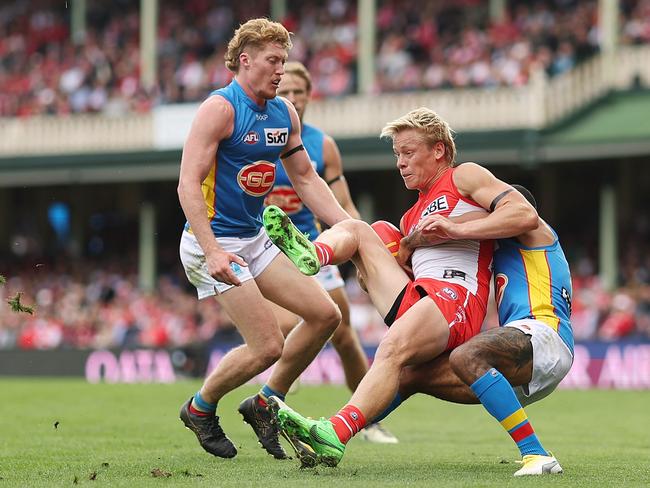 Isaac Heeney is tackled by Touk Miller during the Swans’ win over the Suns. Picture: Mark Metcalfe/AFL Photos/via Getty Images.