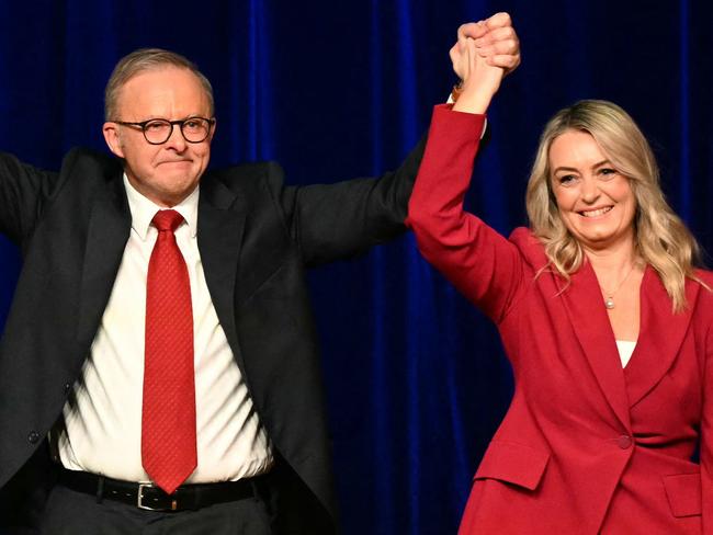 Australia's Prime Minister Anthony Albanese celebrates with his partner Jodie Haydon (R), son Nathan and Australia's Foreign Minister Penny Wong (L) after winning the general election at the Labor Party election night event in Sydney on May 3, 2025. Left-leaning Prime Minister Anthony Albanese triumphed on May 3 in Australia's general election, according to media projections, prevailing in a vote shaped by inflation woes and Trump tariffs. (Photo by Saeed KHAN / AFP)