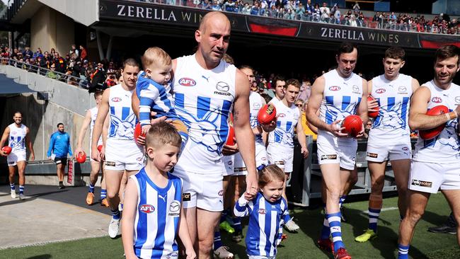 Ben Cunnington of the Kangaroos walks out with his children before the game against Adelaide. (Photo by James Elsby/AFL Photos via Getty Images)