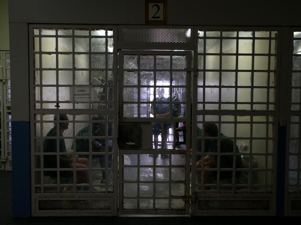 Prisoners wait in a holding cell while in the process of being transfered for a court appearance or to another jail. Picture: Adam Taylor