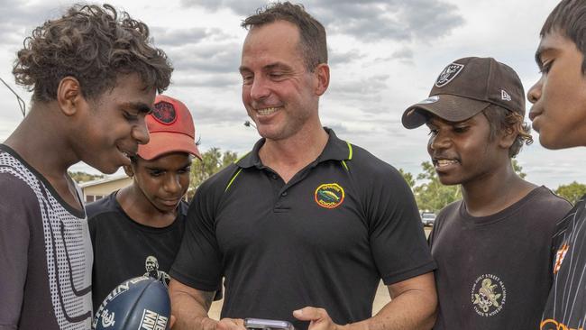 26/04/2023: Alice Springs based Yipirinya School principal Gavin Morris with students on the school grounds. Malikai Hayes, Keylin Peters (red cap), Adrian Nelson (black cap) & Jahquille Stuart (rat tail). PIC: Grenville Turner