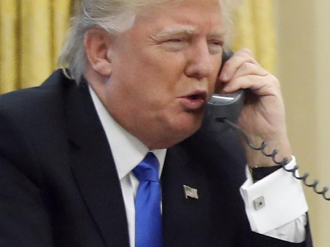 FILE - In this Jan. 28, 2017, file photo, President Donald Trump speaks on the phone with Prime Minister of Australia Malcolm Turnbull in the Oval Office of the White House in Washington. Trump, who blasted Hillary Clinton for using a personal email server, might be a walking magnet for eavesdropping and malware if he is using an unsecured cellphone to chat with foreign leaders. Trump has been handing out his cellphone number to counterparts around the world, urging them to call him directly to avoid the red tape of diplomatic communications. The practice has raised concern about the security and secrecy of the U.S. commander-in-chief's communications. (AP Photo/Alex Brandon, File)