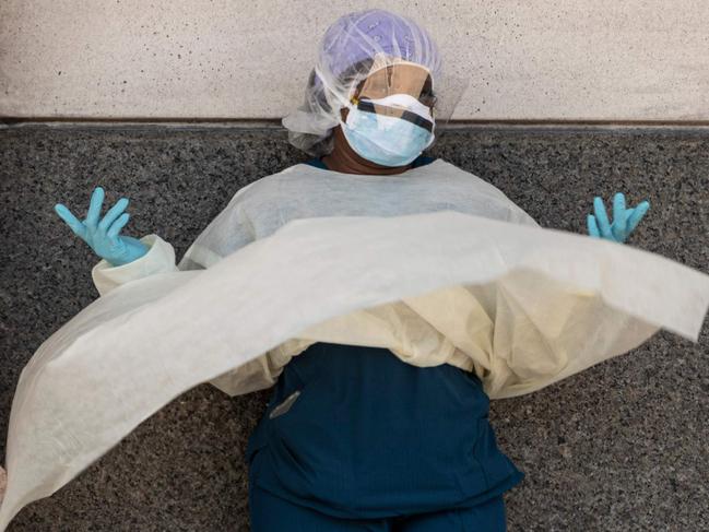 TOPSHOT - A medical worker makes a phone call during her break outside a special COVID-19 illness area at Maimonides Medical Center on May 17, 2020  in the Brooklyn borough of New York City. (Photo by Johannes EISELE / AFP)