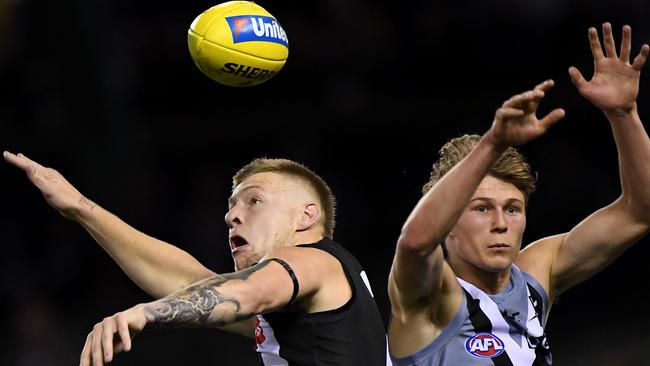 Jordan De Goey of the Magpies (left) and Xavier Duursma of the Power contest a mark during the clash at Marvel Stadium on Friday. Picture: AAP Image/Julian Smith