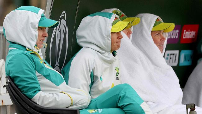 New Zealand players and staff wrap up against the cold during the Women's Cricket World Cup match between the Australia and Bangladesh at the Basin Reserve in Wellington on March 25, 2022. (Photo by Marty MELVILLE / AFP)