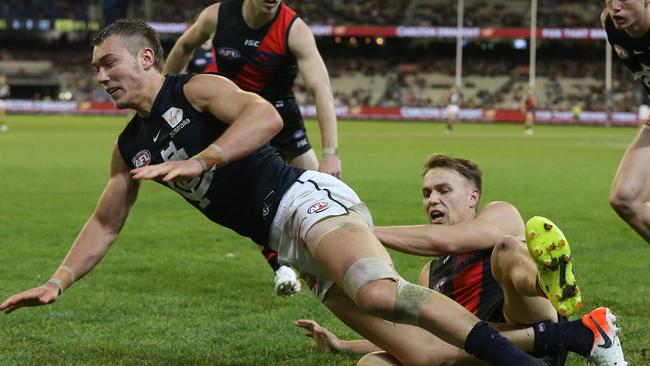 Essendon’s Dylan Clarke keeps a close check on Patrick Cripps. Picture: Michael Klein