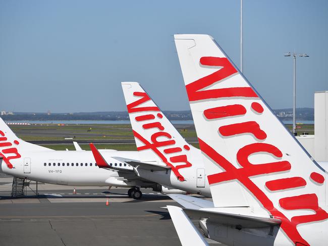 A general view of Virgin Australia aircraft parked at Sydney Domestic Airport, in Sydney, Tuesday, April 21, 2020. Virgin confirmed it had gone into administration on Tuesday, threatening up to 10,000 airline jobs after a board meeting of its international shareholders voted on Monday against providing additional financial support. (AAP Image/Dan Himbrechts) NO ARCHIVINGA general view of Virgin Australia aircraft at Sydney Domestic Airport, in Sydney, Tuesday, April 21, 2020. Virgin confirmed it had gone into administration on Tuesday, threatening up to 10,000 airline jobs after a board meeting of its international shareholders voted on Monday against providing additional financial support. (AAP Image/Dan Himbrechts) NO ARCHIVING