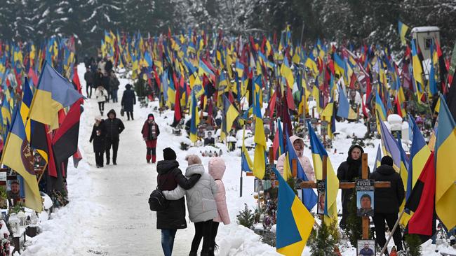 People visit graves of Ukrainian soldiers on the Day of the Armed Forces of Ukraine, in the city of Lviv on Wednesday. Picture: AFP