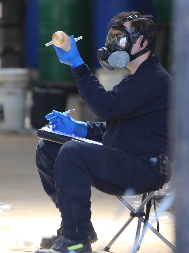 An officer logging evidence removed from the shed. Picture: Police Media