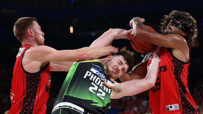 Matt Hurt of the Phoenix contests for a rebound against Dylan Windler and Keanu Pinder of the Wildcats. Picture: Getty Images