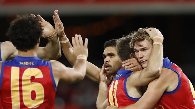 Charlie Cameron (centre) celebrates with teammates during Brisbane’s big win over Essendon. Picture: Ryan Pierse/Getty Images