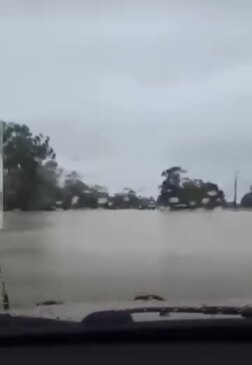 Vehicle swept off road by flood waters near Charleville