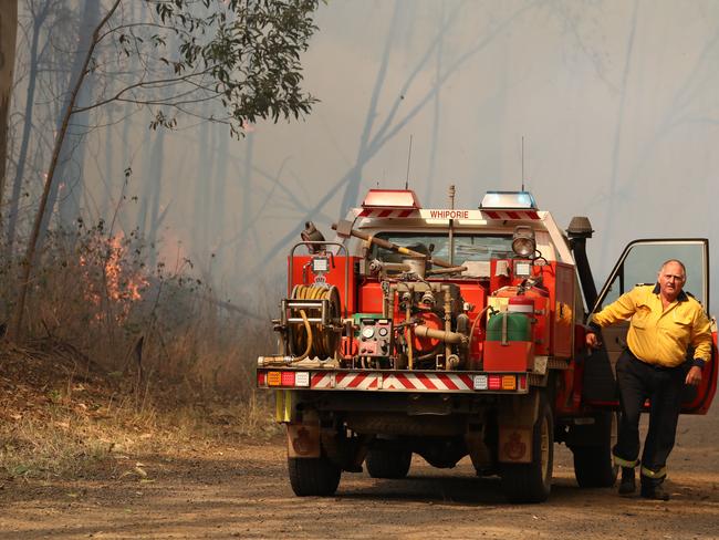 Firefighters battle bushfires in Busbys Flat, northern NSW, Wednesday, October 9, 2019. (AAP Image/Jason O'Brien)