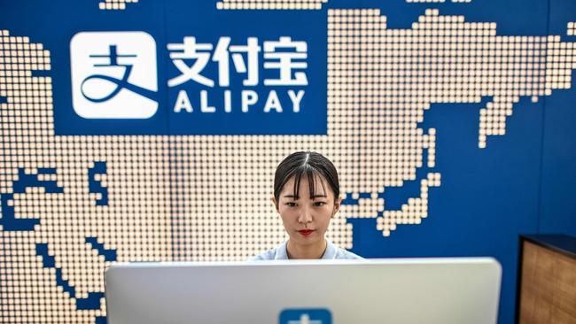 An employee working on a computer at the Alipay reception of the Shanghai office building of Ant Group in Shanghai. Picture: AFP