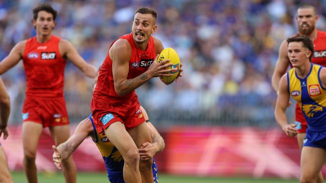 Joel Jeffrey of the Suns handpasses the ball during the 2025 AFL Round 1 match against the West Coast Eagles. Picture: Janelle St Pierre/AFL Photos via Getty Images