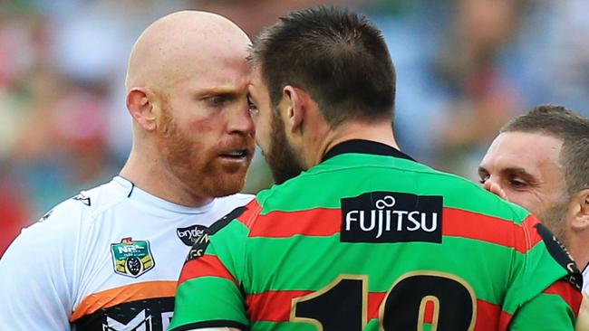 Keith Galloway of the Tigers and Tim Grant of Souths head to head during the Souths v Wests Tigers NRL round 3 game at ANZ Stadium, Homebush. pic Mark Evans