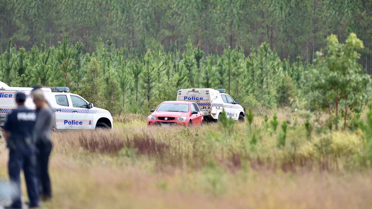 The body of a child and man were found in the red Holden Commodore off Roys Rd, Coochin Creek.