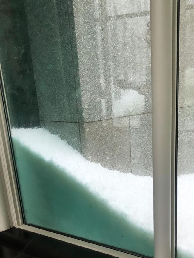 Hail piling up outside the windows of Parliament House. Picture: Instagram