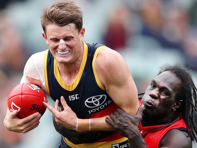 AFL - Sunday, 26th July, 2020 - Adelaide Crows v Essendon at the Adelaide Oval. Matt Crouch under pressure from Essendon's Anthony McDonald-Tipungwuti Picture: Sarah Reed